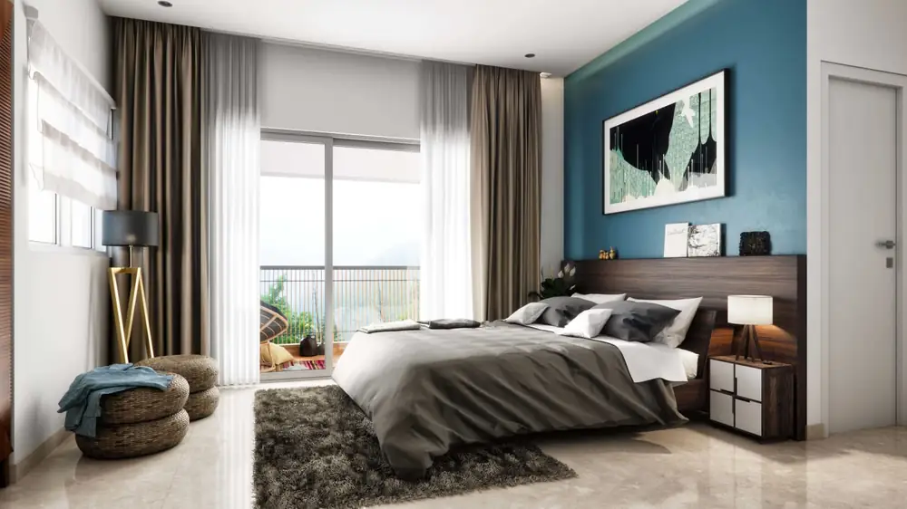 Master bedroom with a double bed, bedside lamps and a sliding door opening onto a private deck.