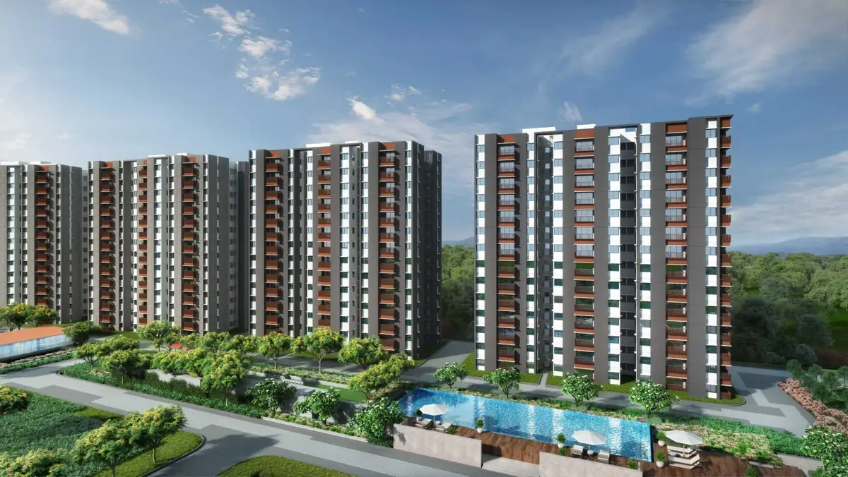 Residential towers at Mahindra World City seen from the landscaped grounds, with a swimming pool in the foreground.